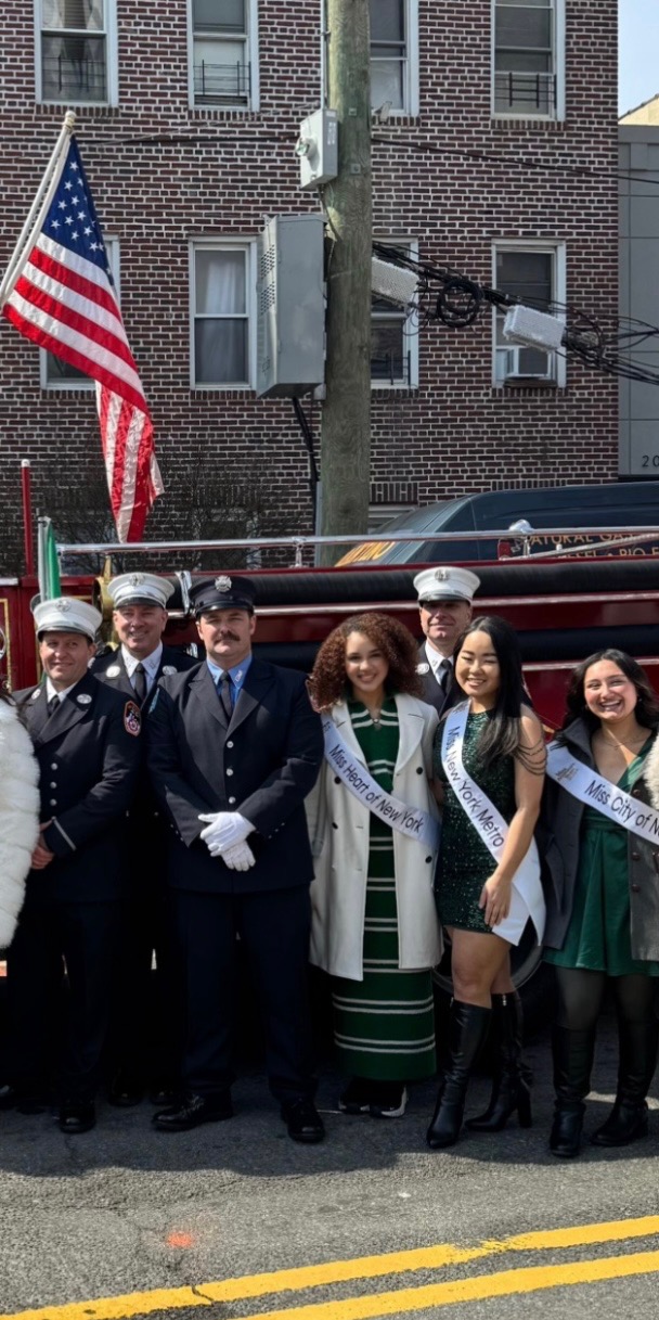 Mary Bellakbira with firefighters and fellow Miss New York contestants in front of a fire truck at a New York appearance